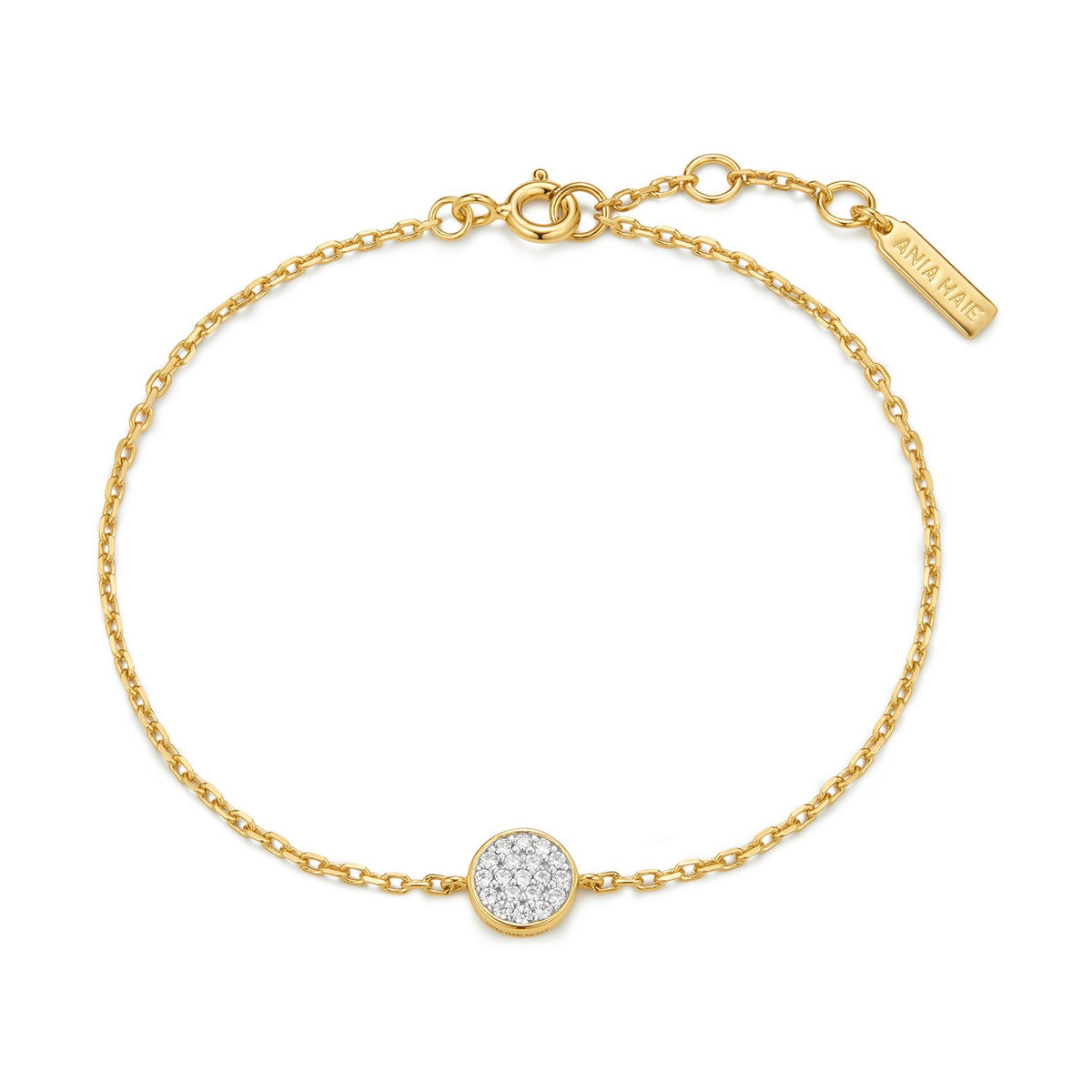 Gold bracelet with a round, diamond-studded charm on a white background