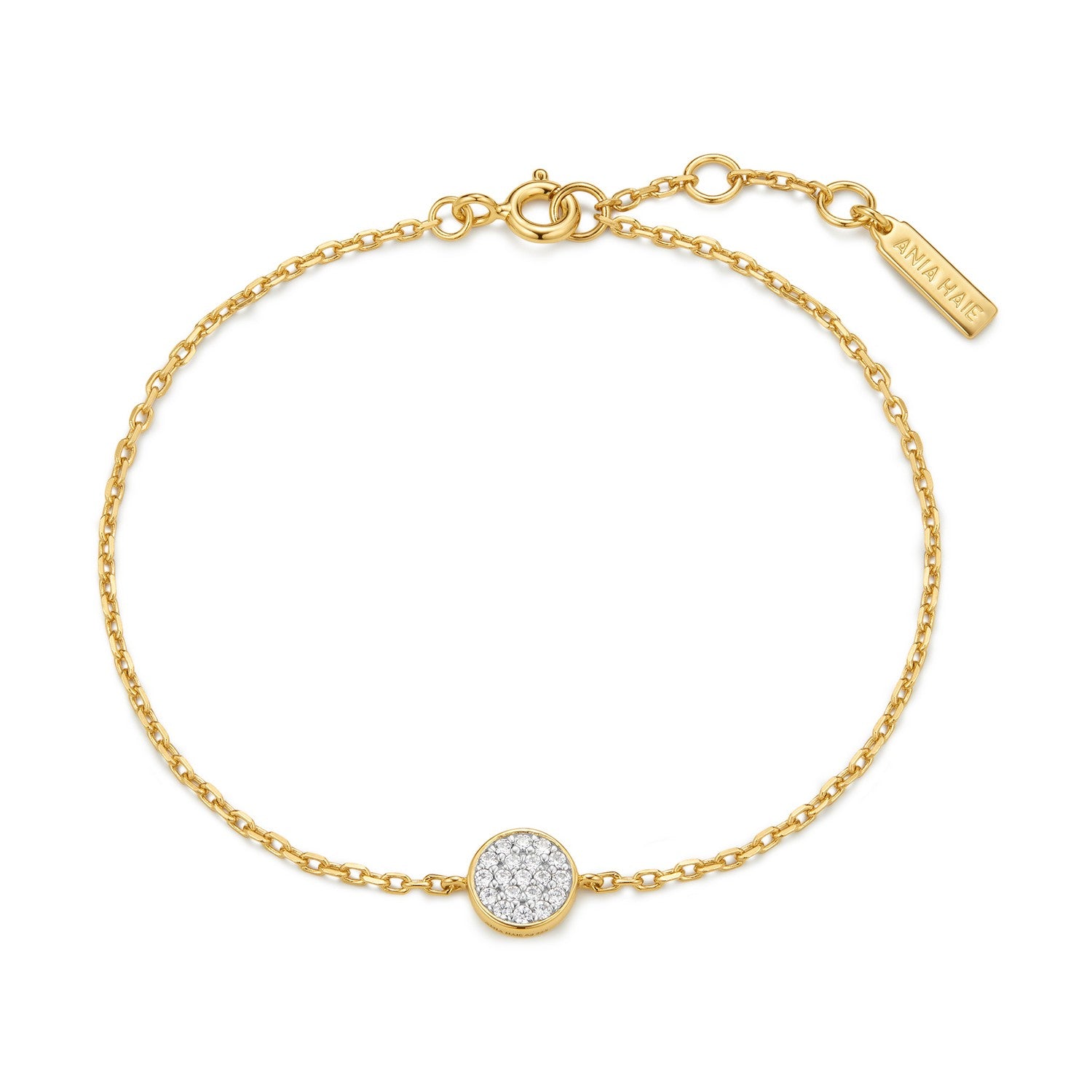Gold bracelet with a round, diamond-studded charm on a white background