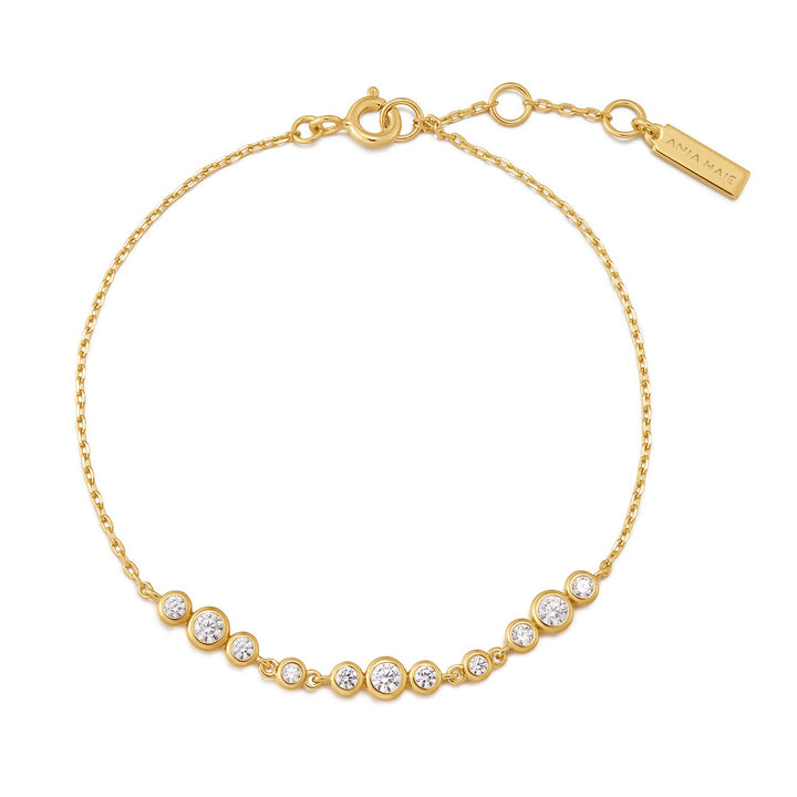 Gold bracelet with clear stones on a white background