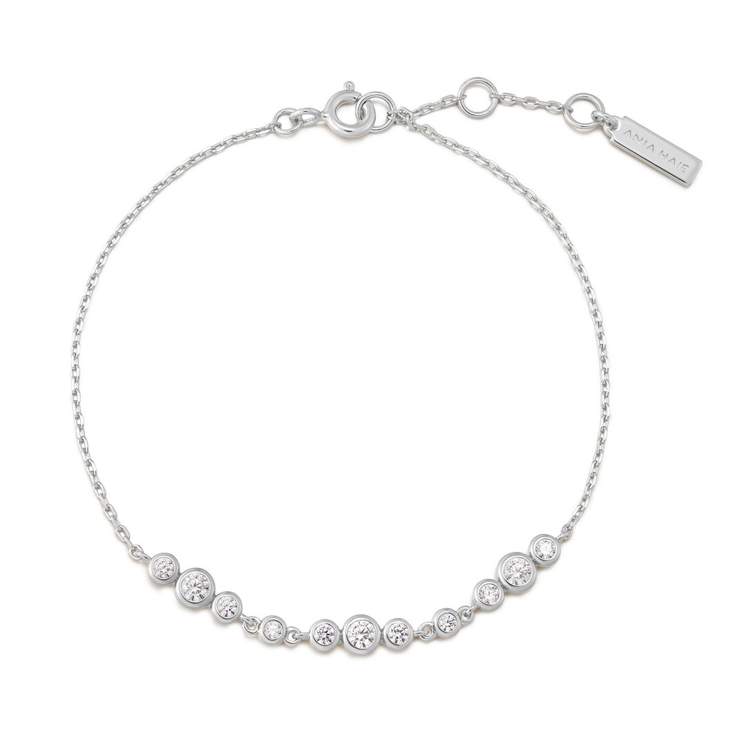 Silver bracelet with clear stones on a white background