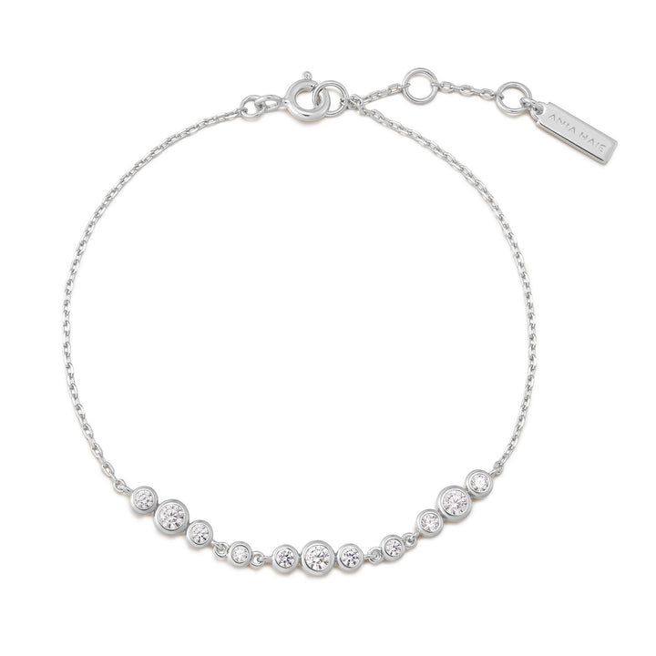 Silver bracelet with clear stones on a white background