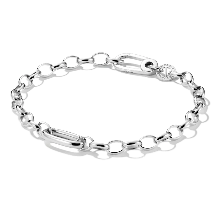 A silver chain link bracelet with a combination of oval links, a polished bar link, and a small round charm, displayed on a clean white background.