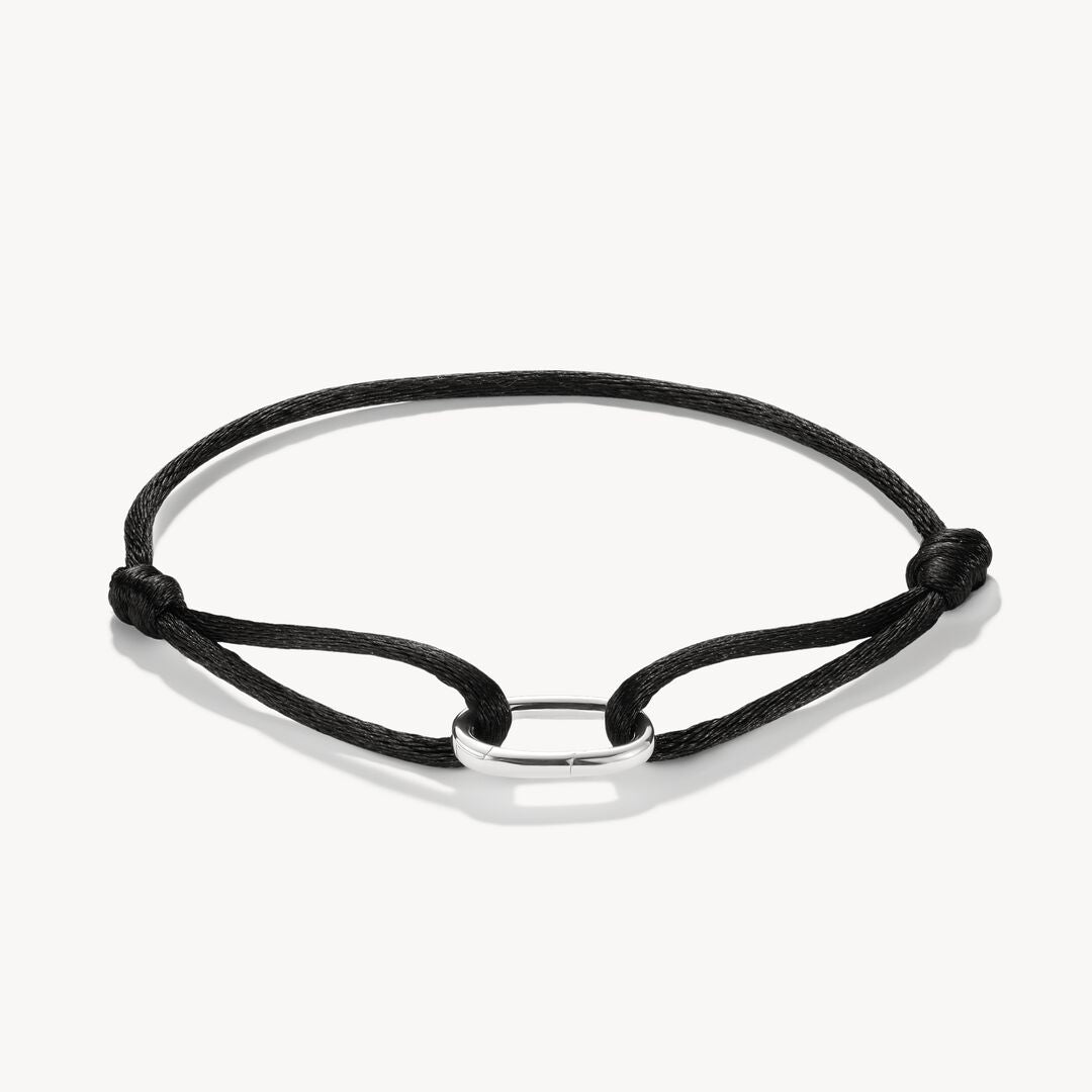 Black cord bracelet with silver clasp on a white background