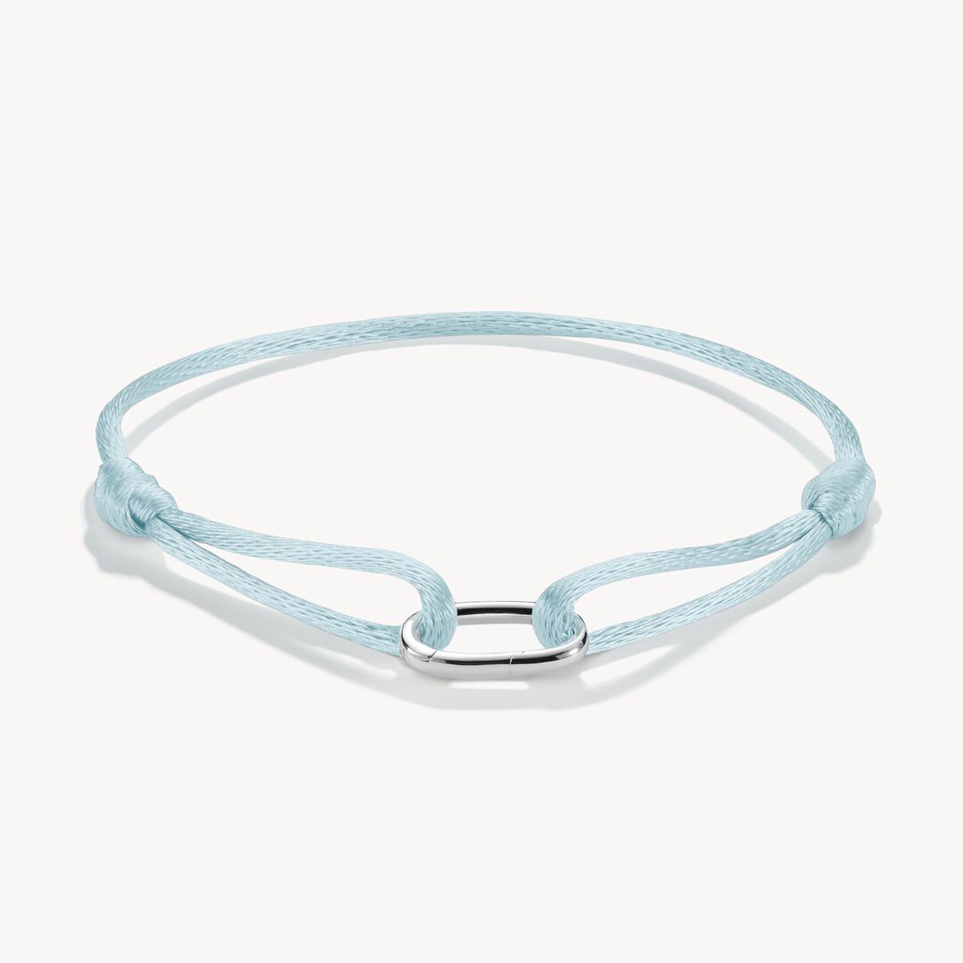 Light blue braided bracelet with a silver clasp on a white background
