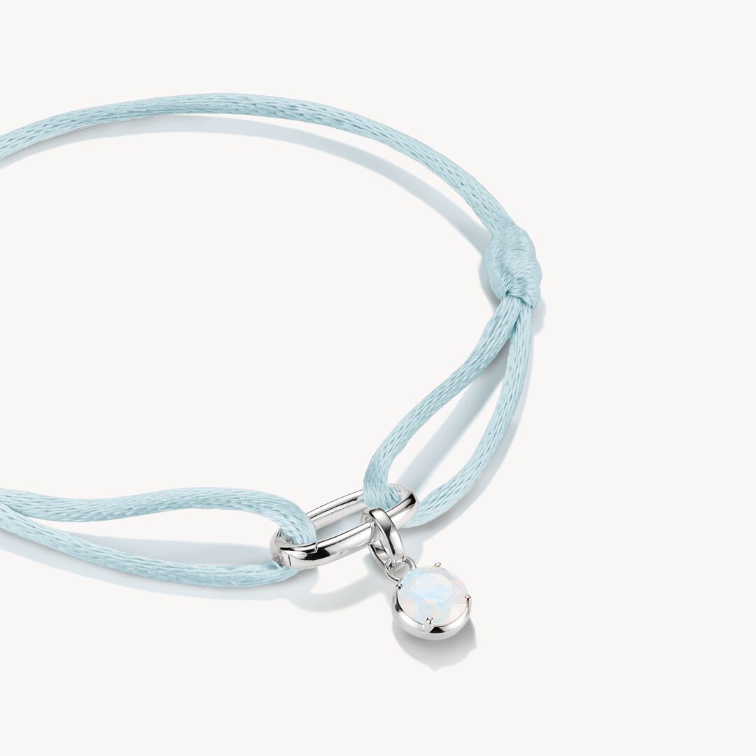 Light blue braided bracelet with a silver clasp on a white background