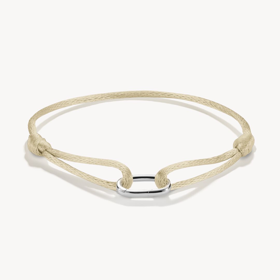 Beige braided bracelet with a silver clasp on a white background