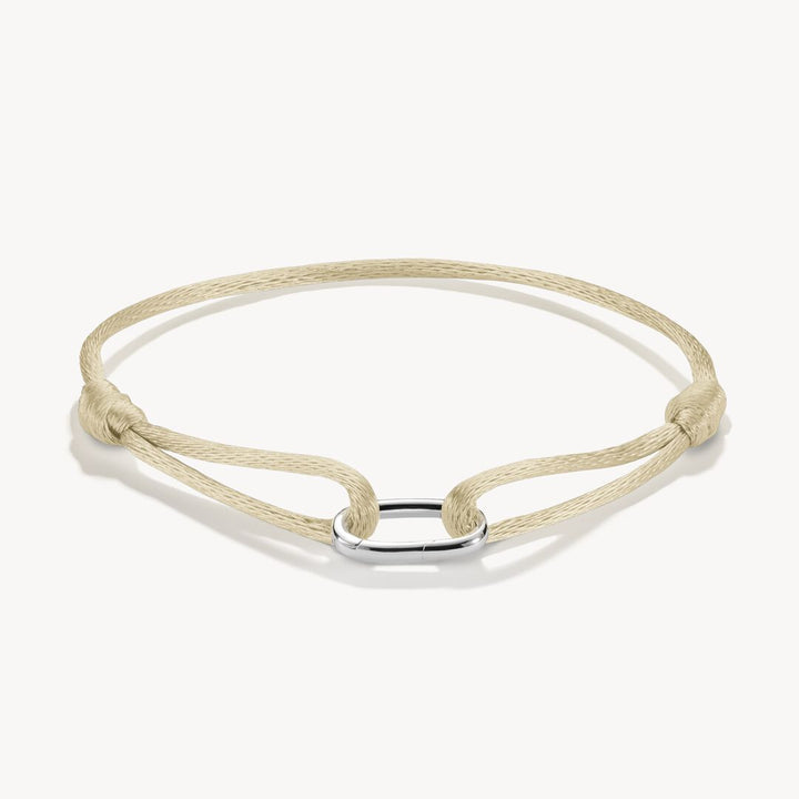 Beige braided bracelet with a silver clasp on a white background