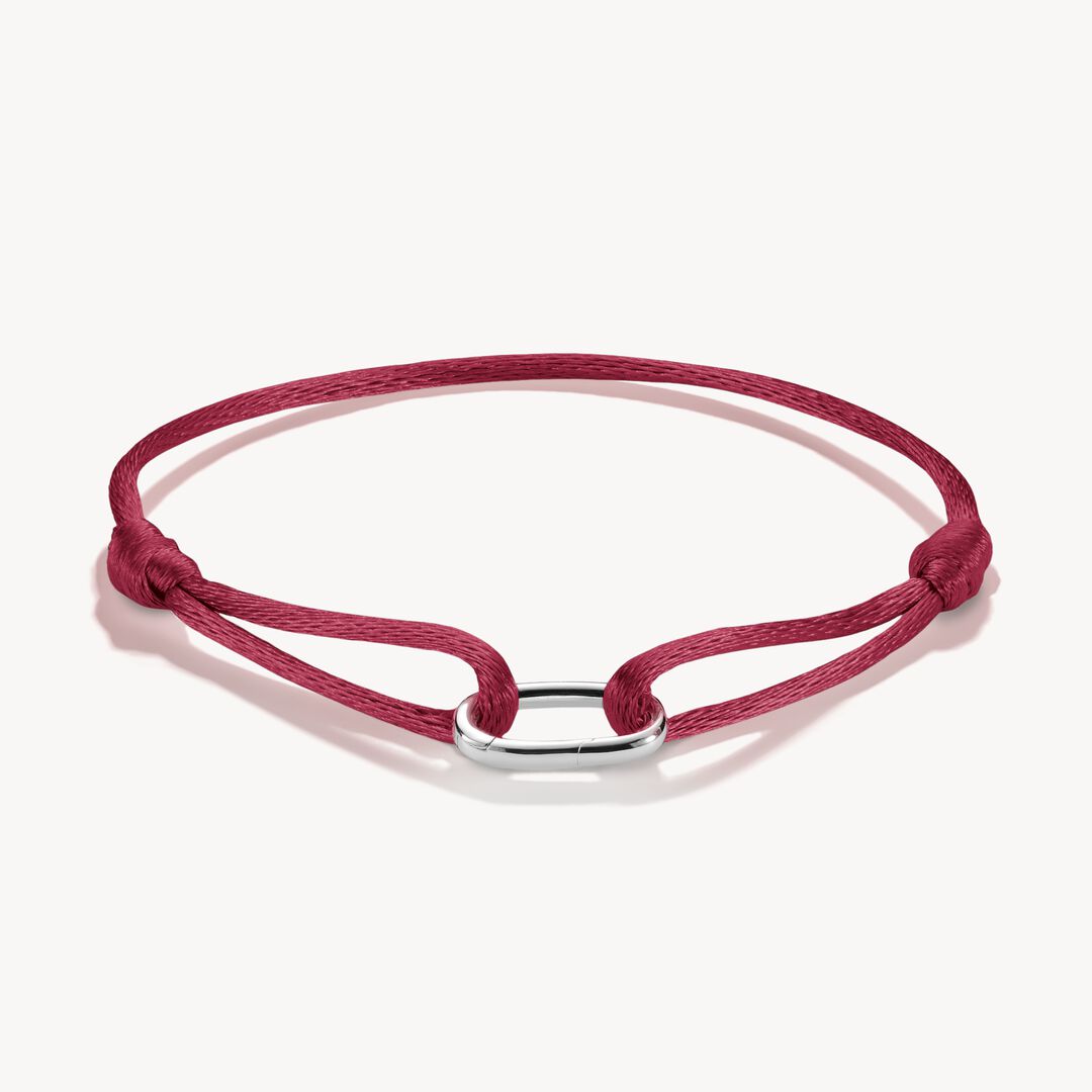 Red bracelet with a silver clasp on a white background