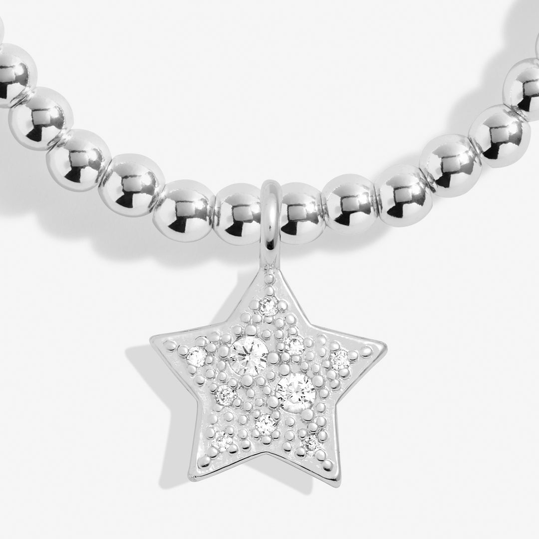 a silver beaded necklace with a star charm