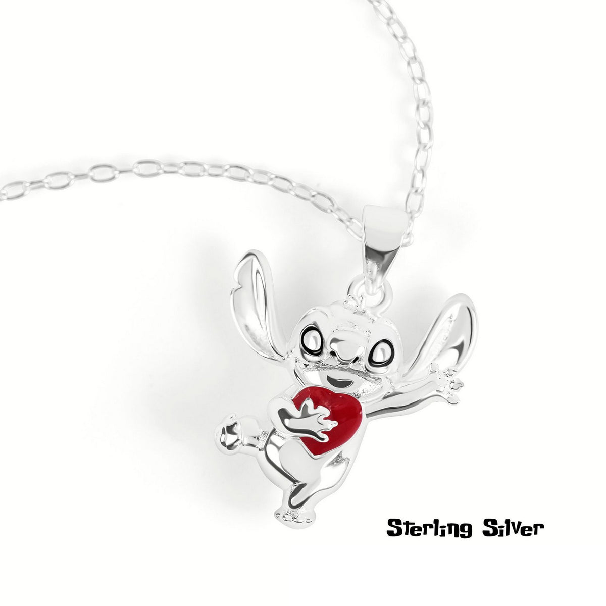 Silver charm shaped like a cartoon character with a red heart on a white background