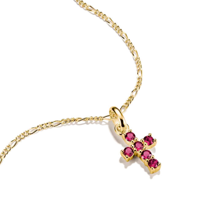 A gold cross pendant necklace adorned with five round-cut pink gemstones, suspended from a gold Figaro chain on a clean white background.