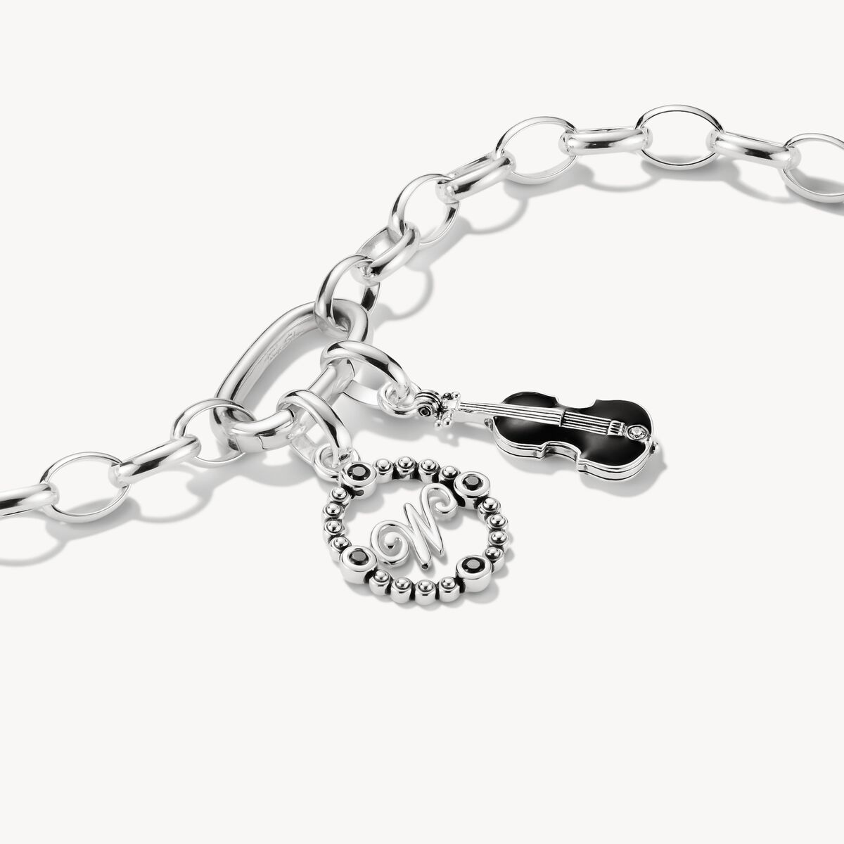 Silver bracelet with charms on a white background