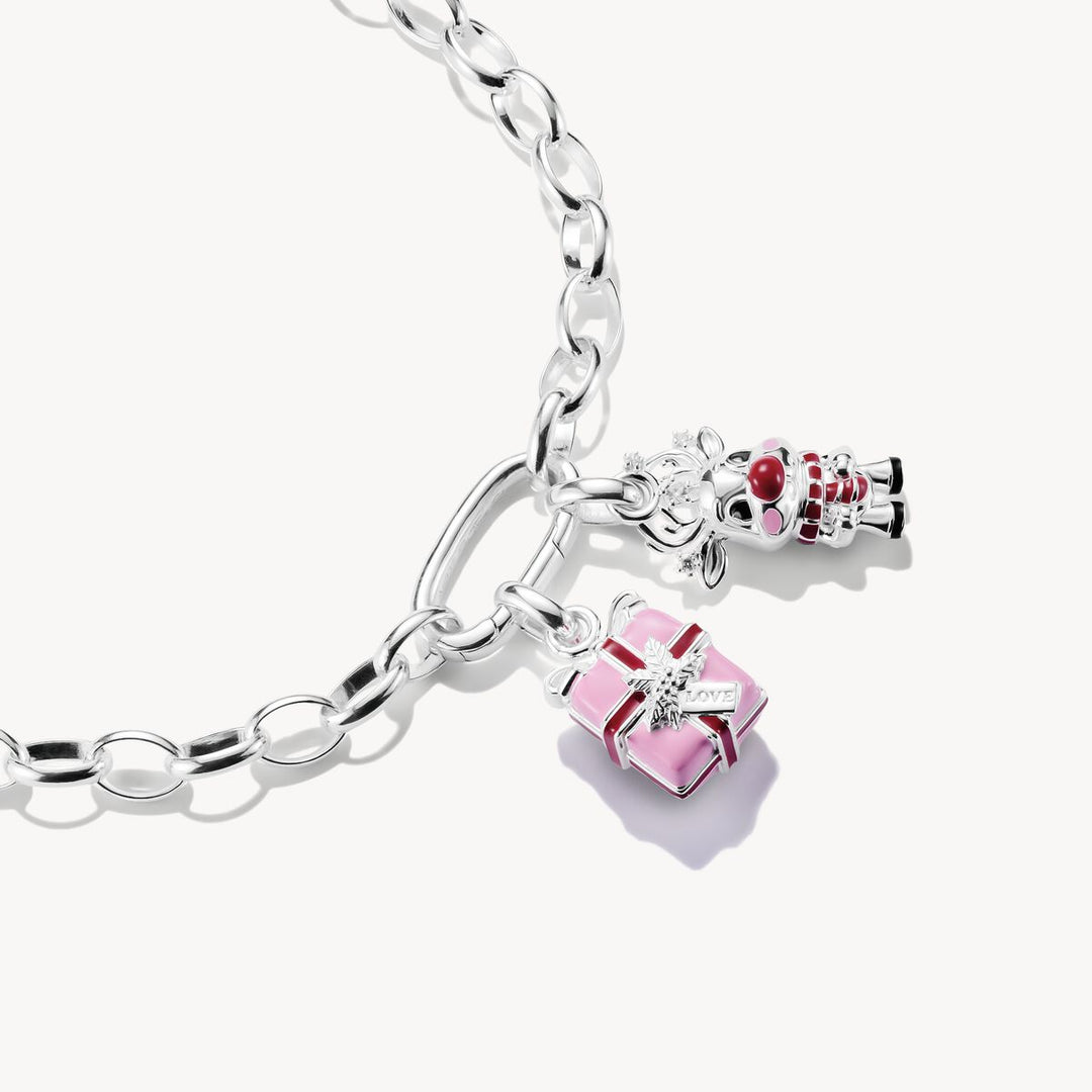Silver bracelet with pink gift box and red wine glass charms on a white background