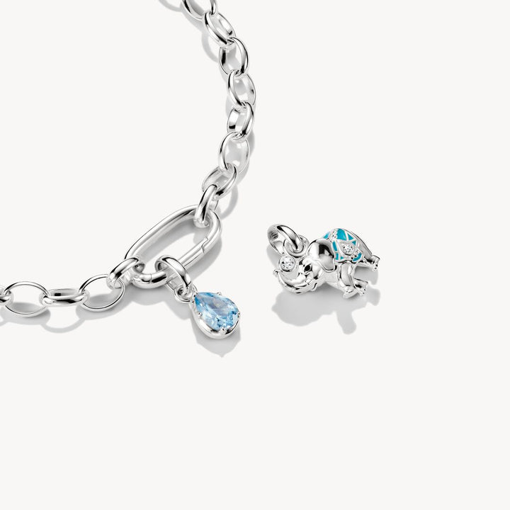 Silver bracelet with heart-shaped and teardrop-shaped charms on a white background