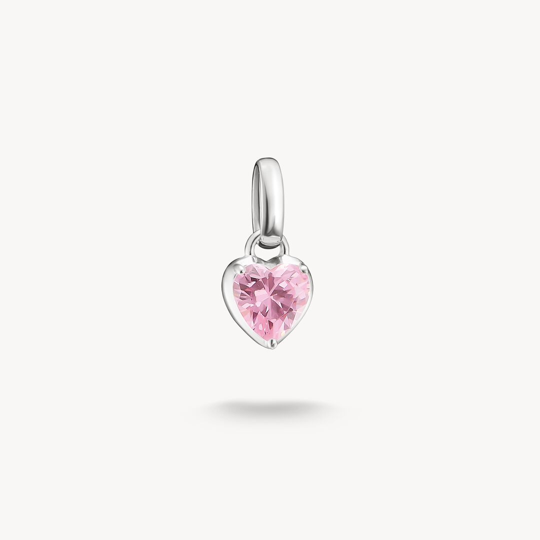 Heart-shaped pendant with a pink gemstone on a white background