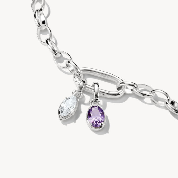 Silver bracelet with two charm pendants on a white background