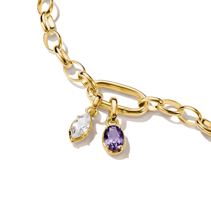 Gold chain bracelet with two dangling charms: a clear marquise-cut gemstone and a purple teardrop-cut gemstone, shown on a white background.
