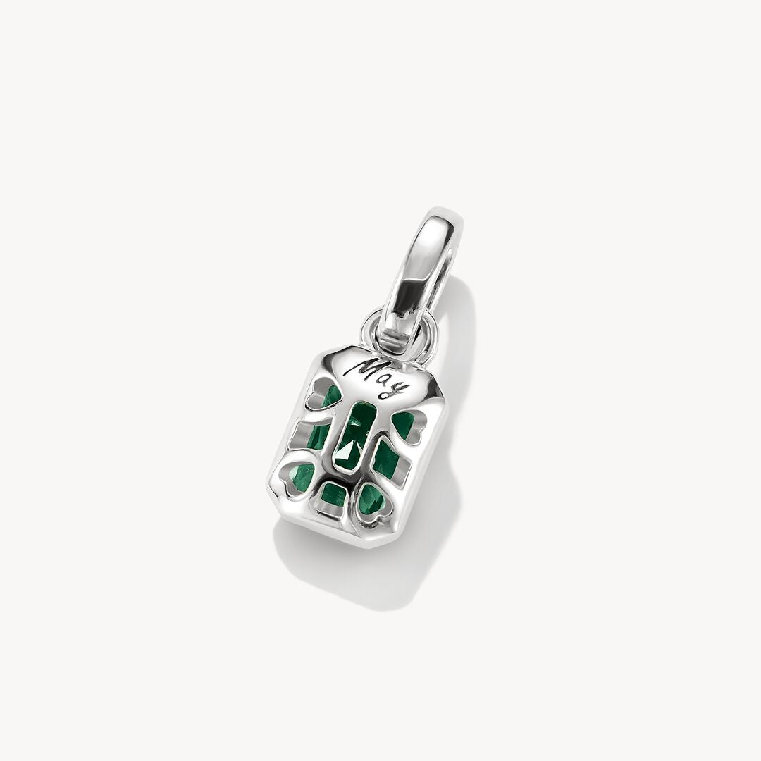 Silver pendant with a green gemstone on a white background