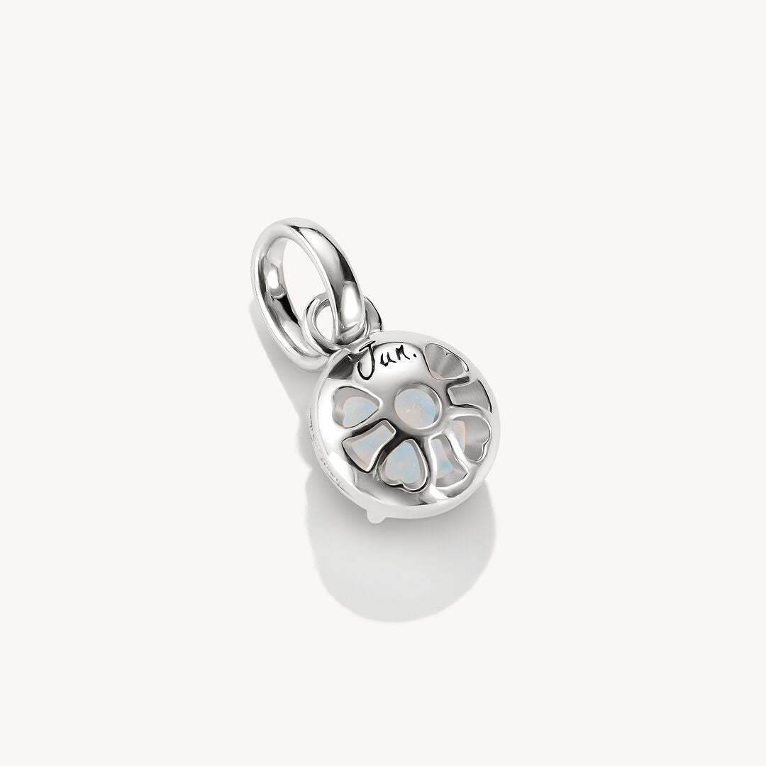 Silver pendant with a round, faceted gemstone on a white background