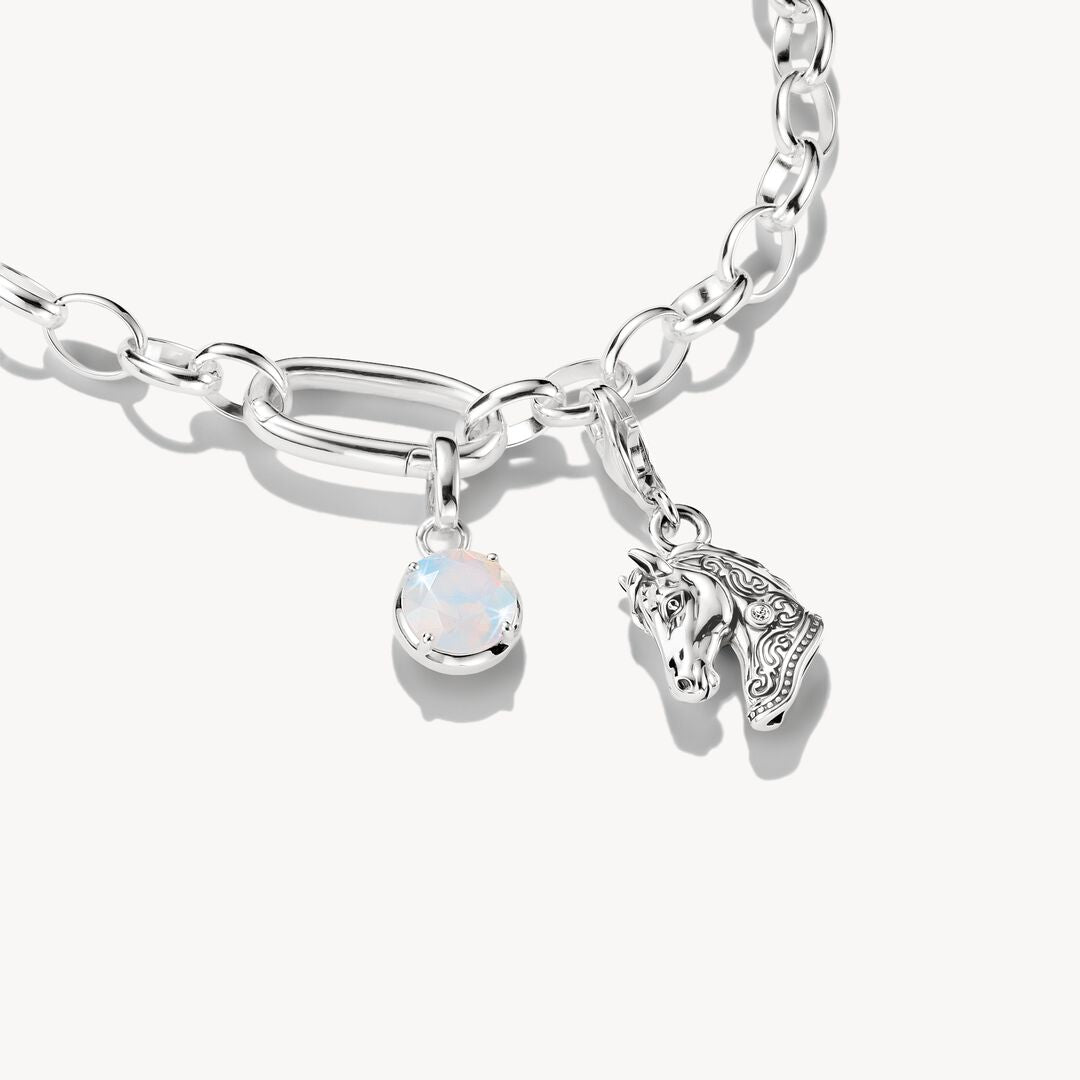 Silver bracelet with a unicorn charm and opal stone on a white background