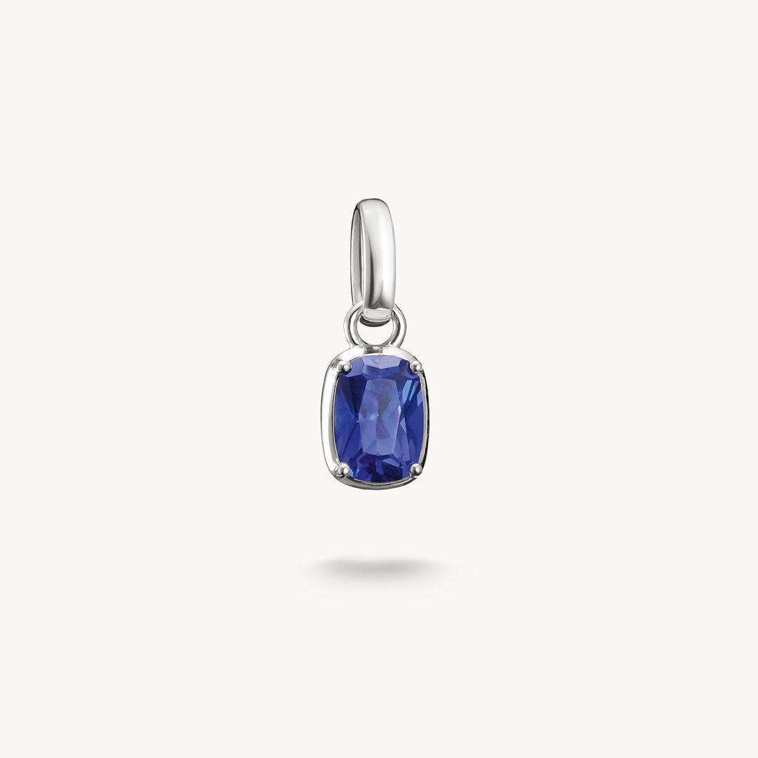 Silver pendant with a blue gemstone on a white background