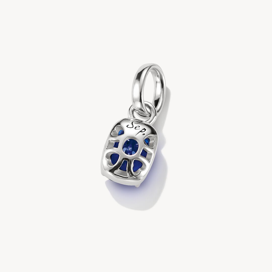 Silver pendant with a blue gemstone on a white background