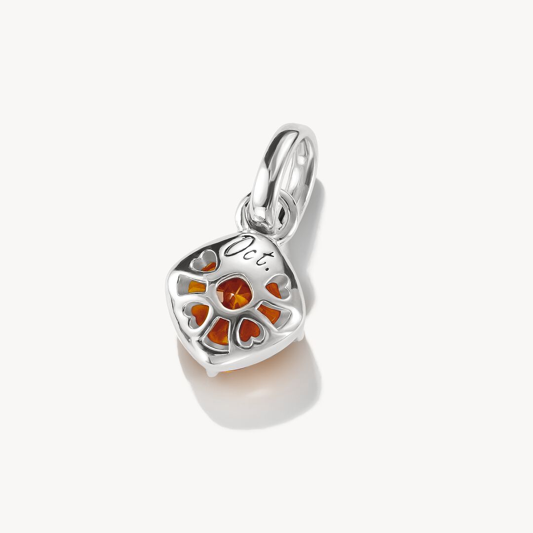Silver pendant with a orange gemstone on a white background