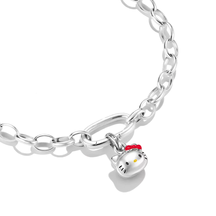 A silver chain bracelet featuring a Hello Kitty character charm with a red bow and yellow nose, shown on a clean white background.