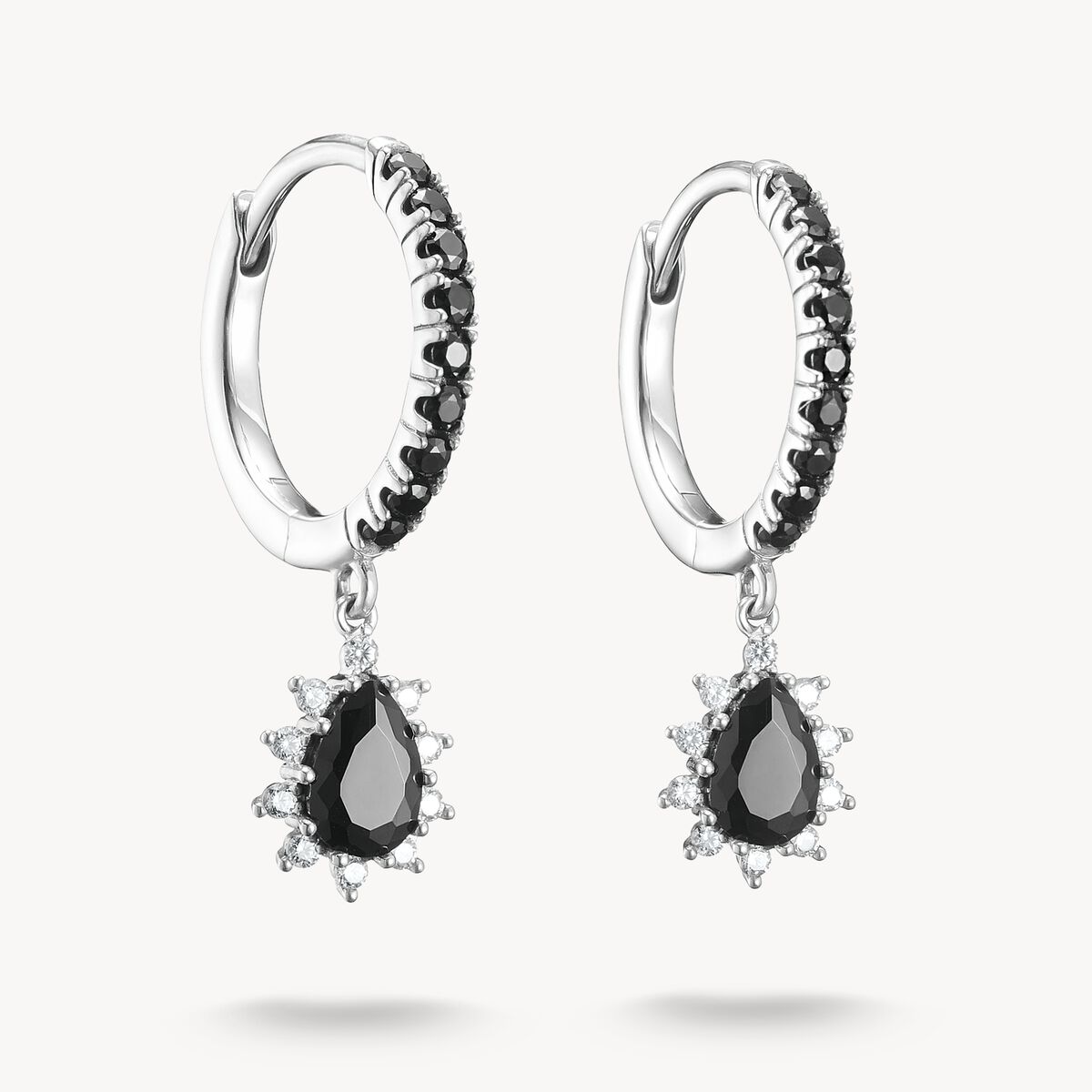 Pair of hoop earrings with black teardrop gemstones on a white background