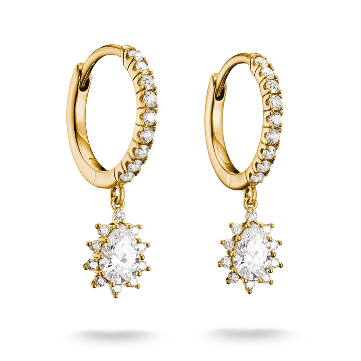 A pair of gold huggie hoop earrings with small clear stones along the front and a dangling starburst cluster featuring a large oval clear center stone surrounded by smaller clear stones, shown on a white background.