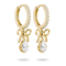 A pair of gold huggie hoop earrings with clear pavé stones along the top band, dangling bow motifs, and teardrop-shaped clear gemstones at the bottom, shown on a white background.
