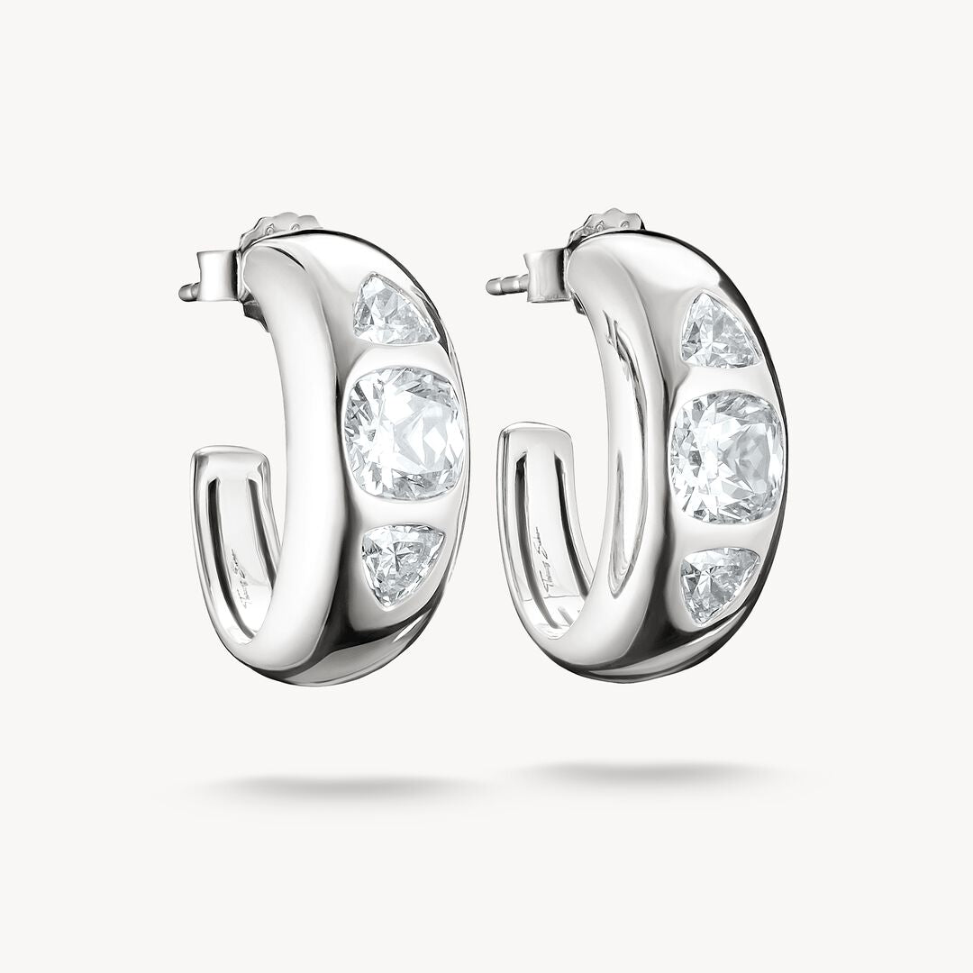 Silver hoop earrings with clear gemstones on a white background