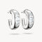 Silver hoop earrings with clear gemstones on a white background