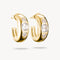 Gold hoop earrings with clear gemstones on a white background