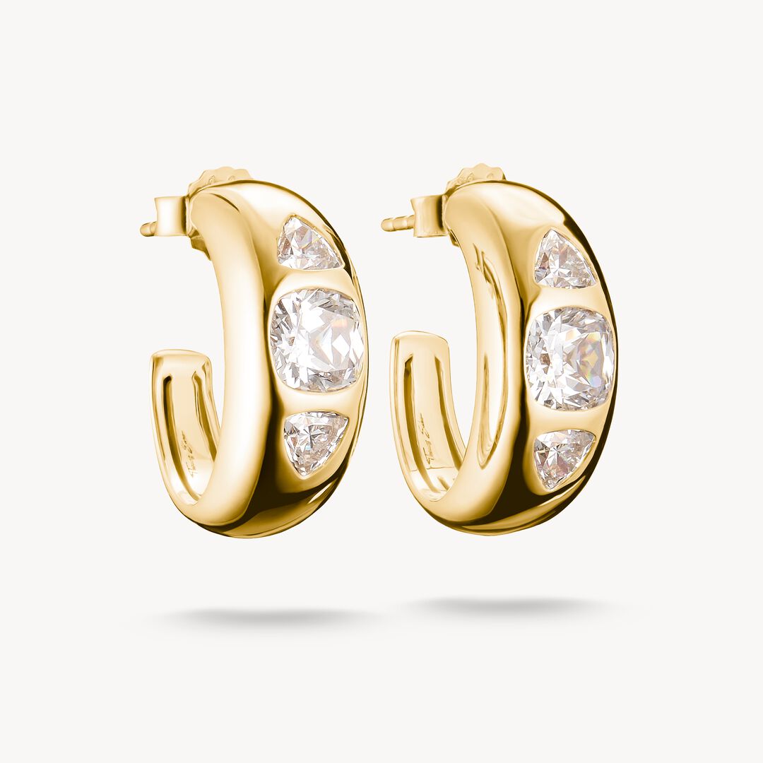Gold hoop earrings with clear gemstones on a white background
