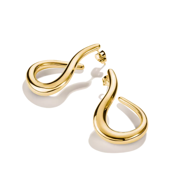 A pair of polished gold huggie hoop earrings with a curved, flowing design, displayed on a clean white background with soft shadows.