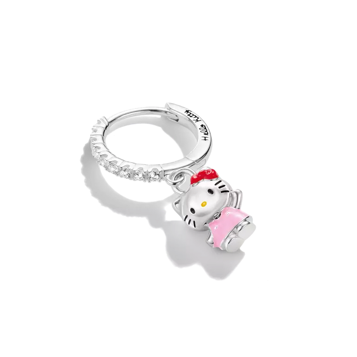 A sterling silver huggie ring featuring a Hello Kitty charm wearing a pink dress and red bow, with clear pavé-set stones along the band, shown on a white background.