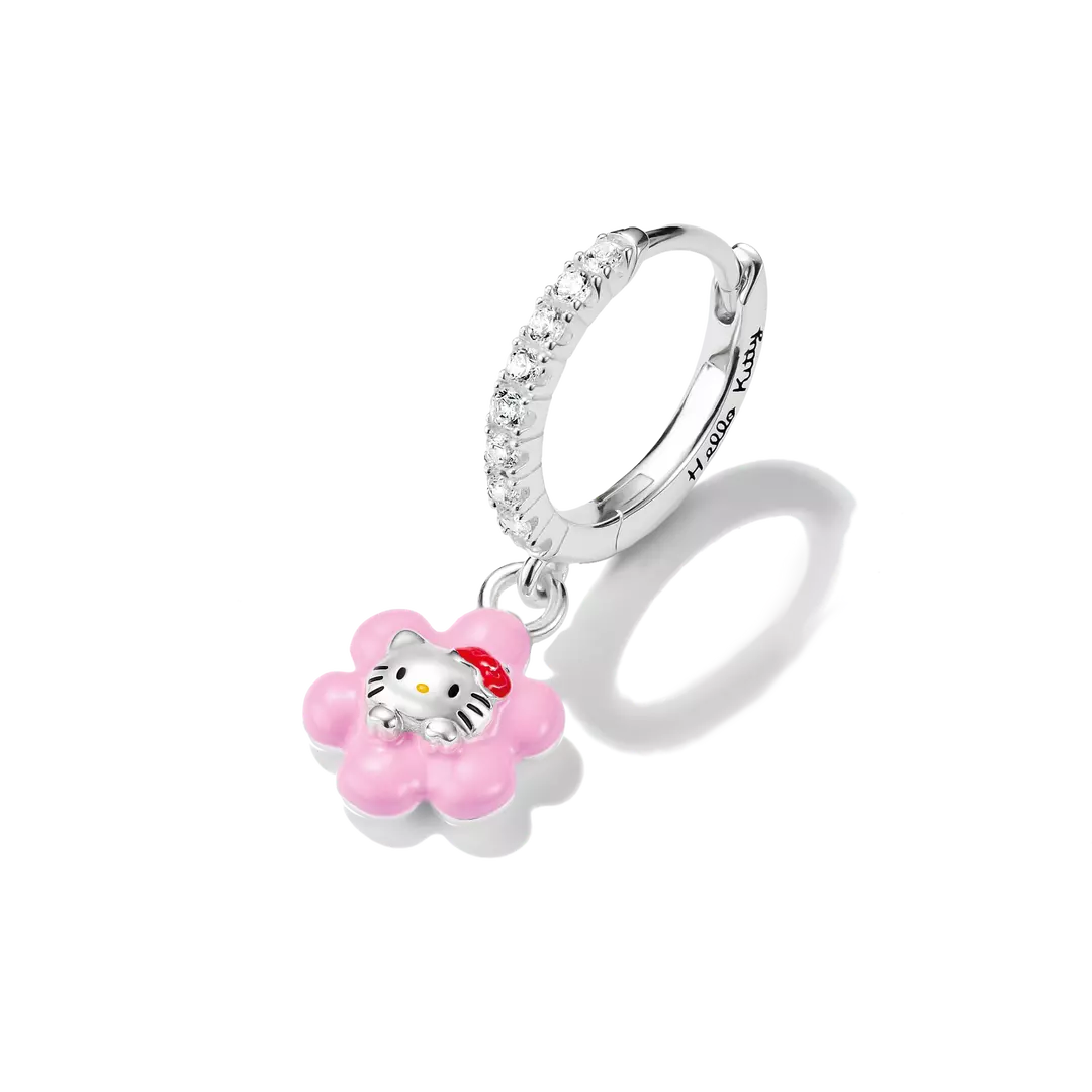 A silver huggie hoop earring adorned with clear crystals and a dangling pink flower charm featuring Hello Kitty in the center, shown on a white background with a soft shadow.
