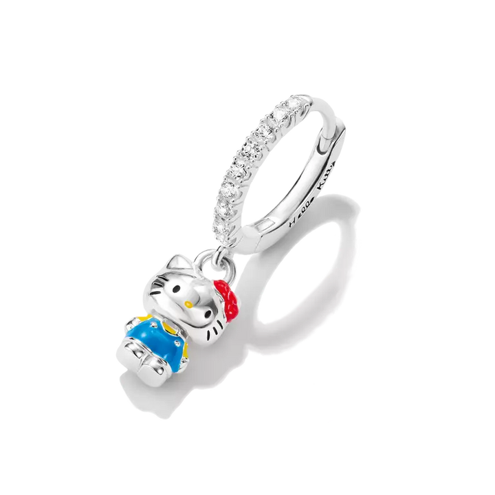 A sterling silver huggie ring charm featuring a Hello Kitty character pendant with blue and red enamel details, set against a clean white background.