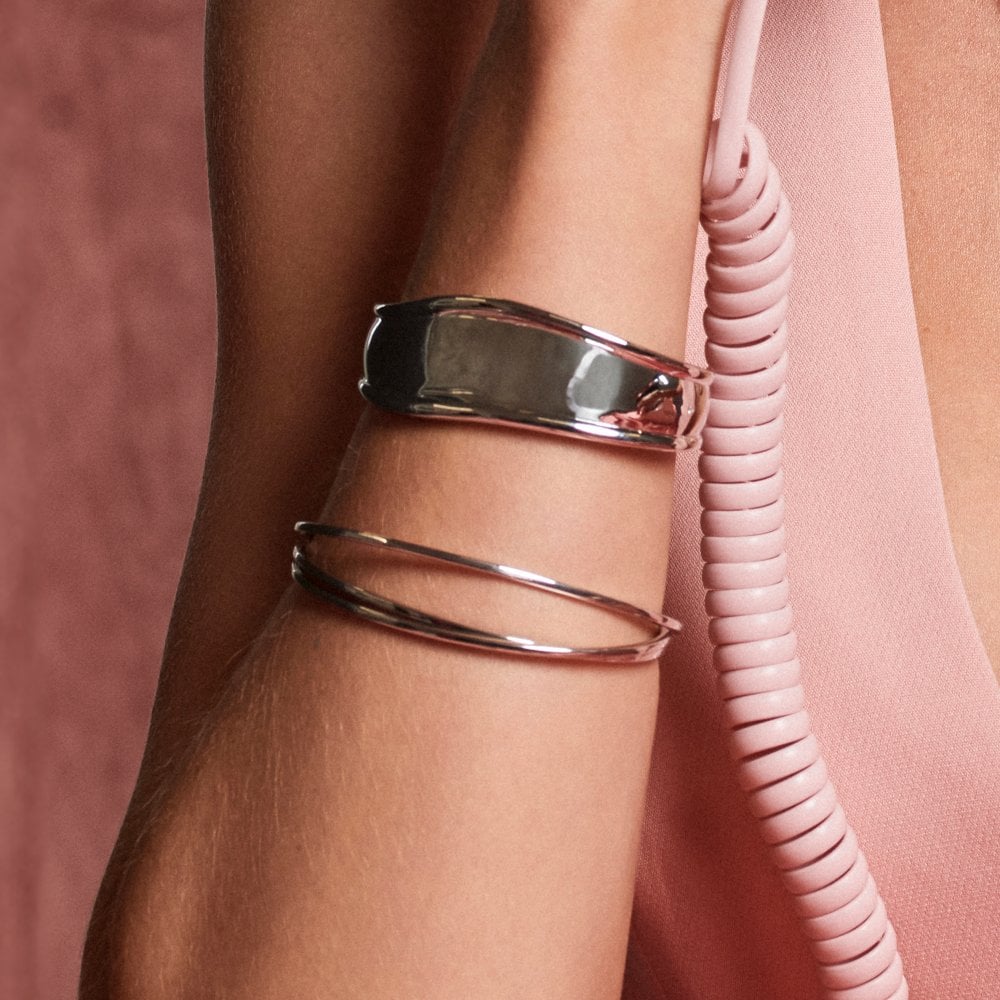 Silver bangles on a wrist 