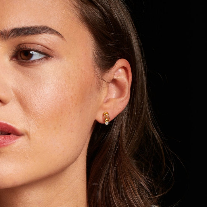 Close-up of a woman wearing gold earrings 