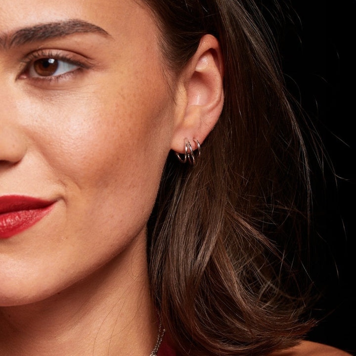 Close-up of a woman wearing a silver earring 