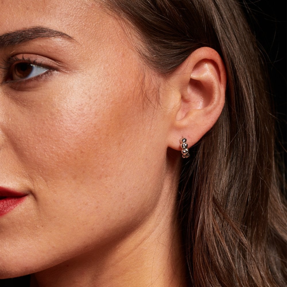 Close-up of a woman's ear with a hoop earring 
