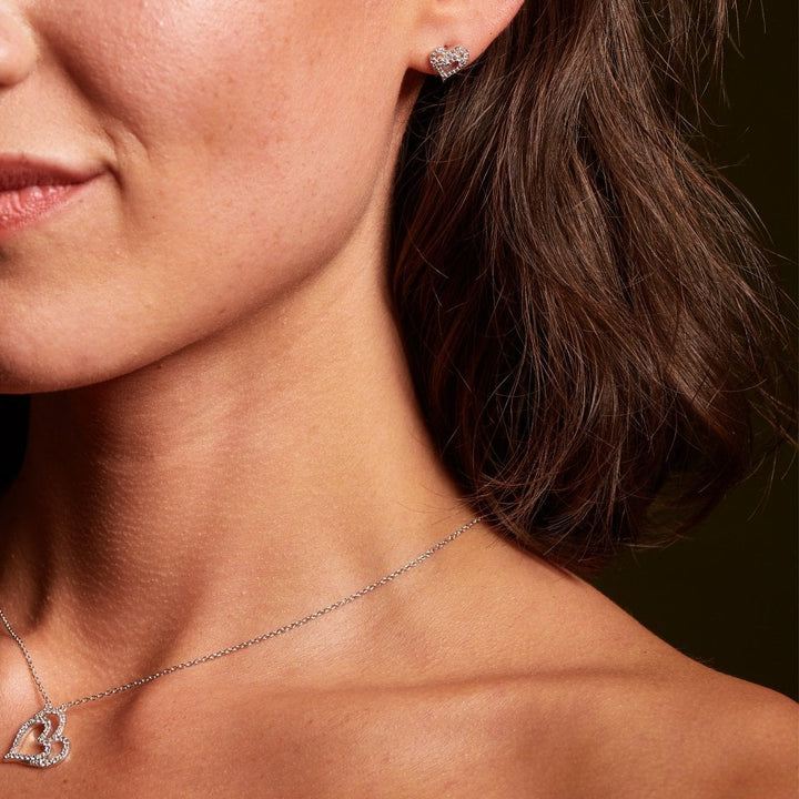 Close-up of a woman wearing a necklace and earrings 