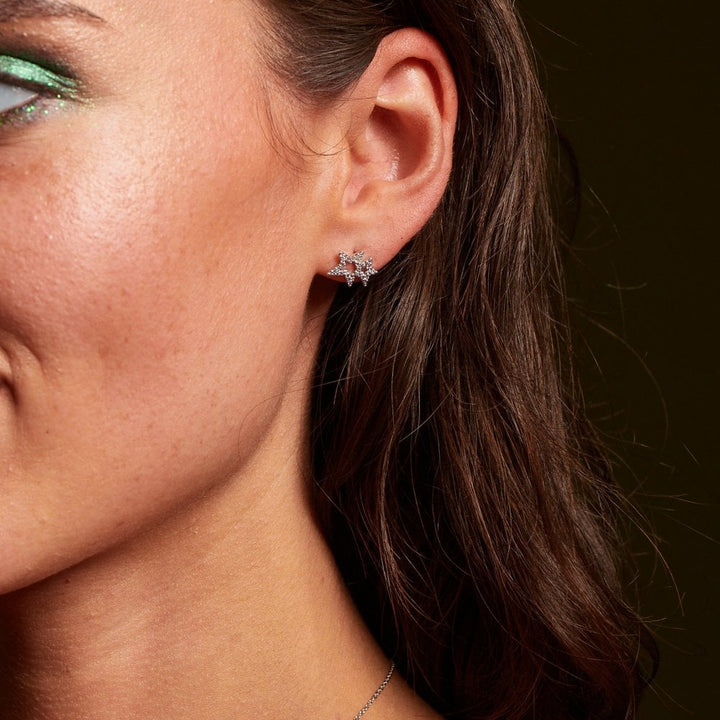Close-up of a person wearing a star-shaped earring 