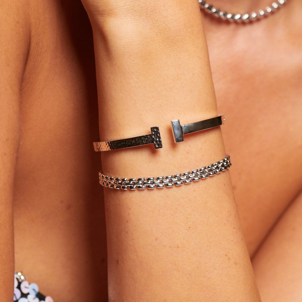 Close-up of a person's arm wearing multiple bracelets 