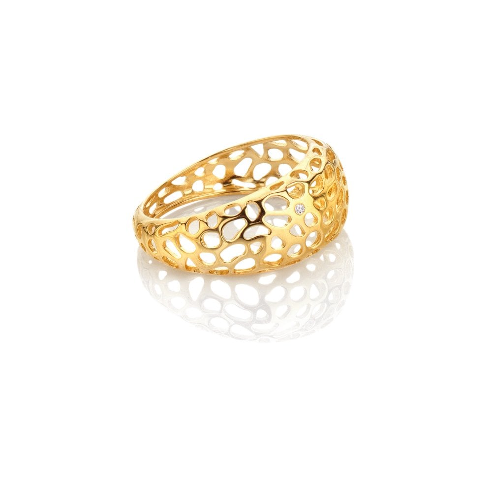 Gold ring with a openwork design on a white background