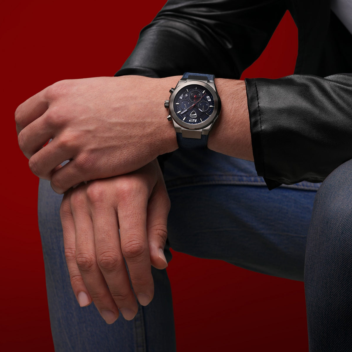 Person wearing a watch on a red background