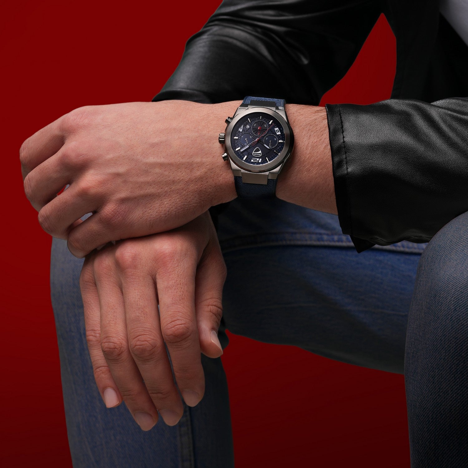 Person wearing a watch on a red background