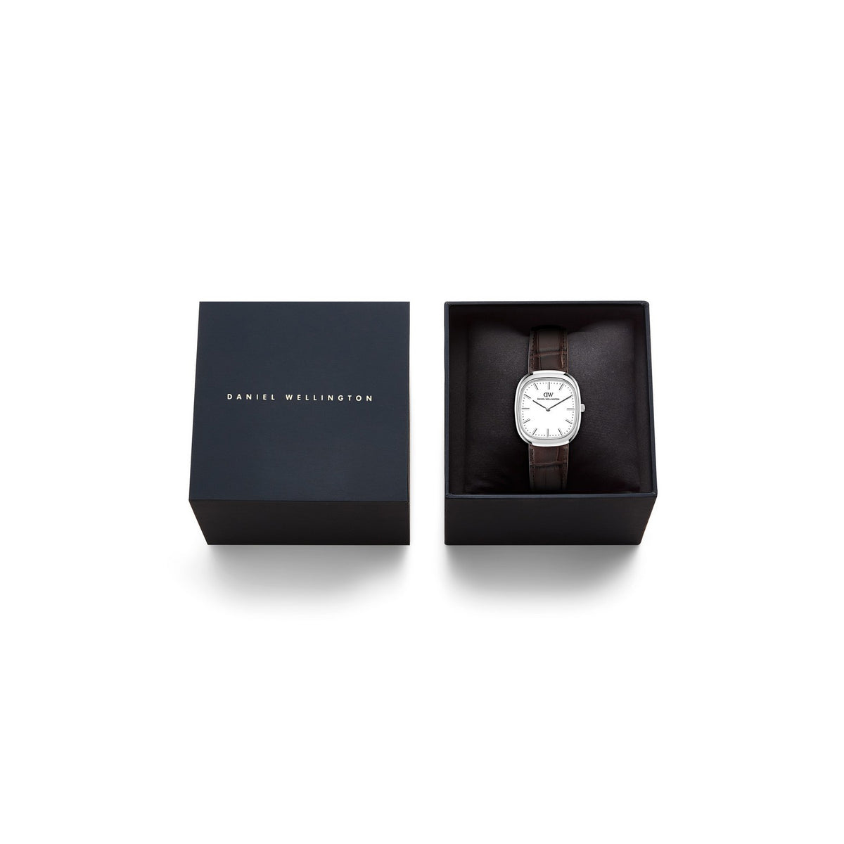 Daniel Wellington wristwatch with a silver-toned rectangular case and brown leather strap, displayed inside an open black presentation box next to its closed lid on a white background.